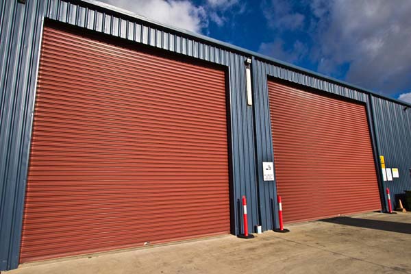Red steel roller shutters on an industrial building